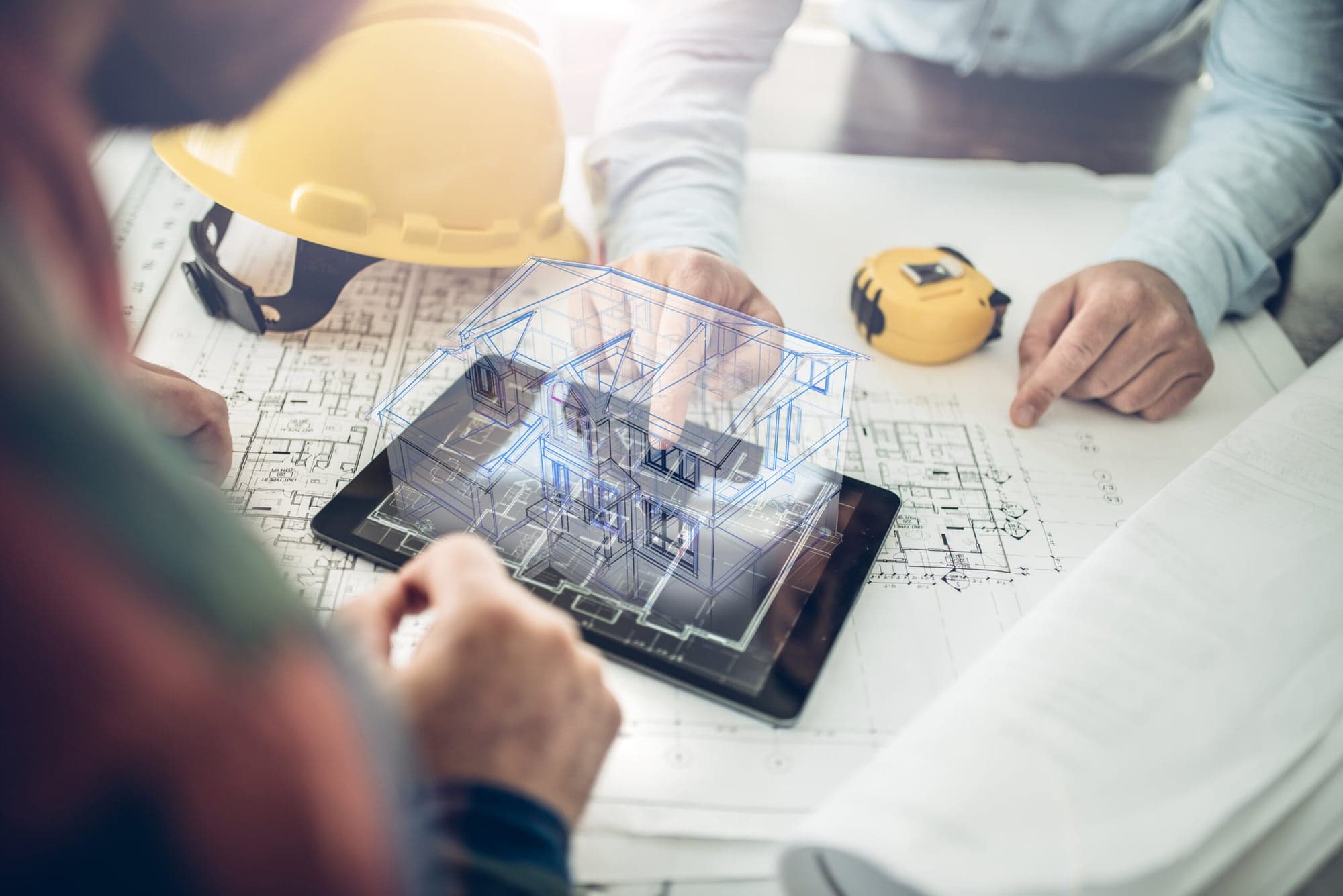 Architect conducting a digital building survey with a 3D model on a tablet and building plans, fbnSTUDIO Wiesbaden