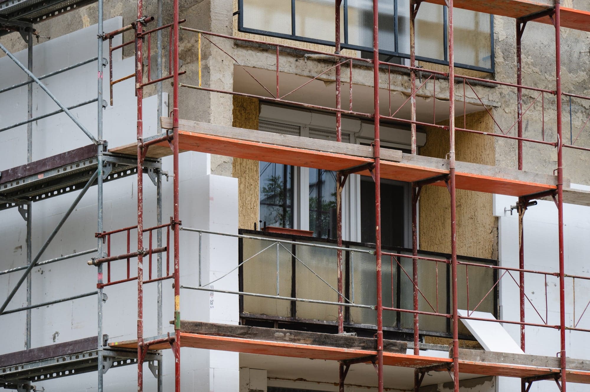 Building façade with scaffolding and thermal insulation during energy-efficient refurbishment, architecture practice in Wiesbaden