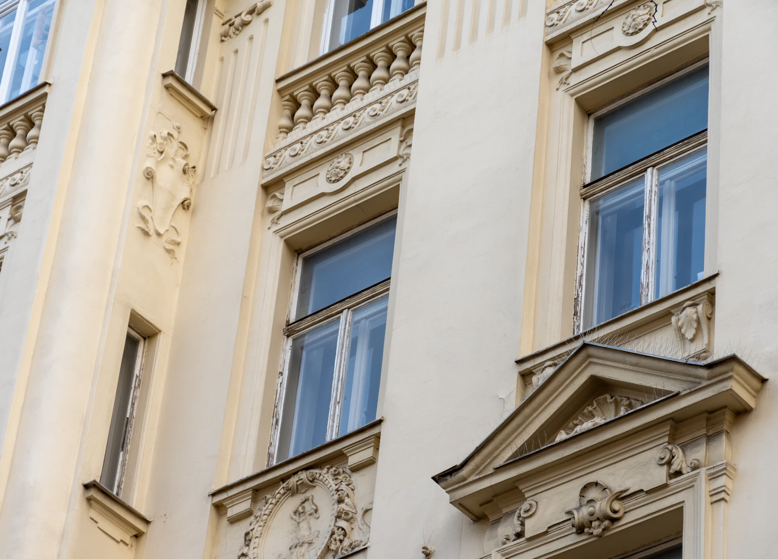 The facade of an old townhouse with decorative balconies and classic European architecture.